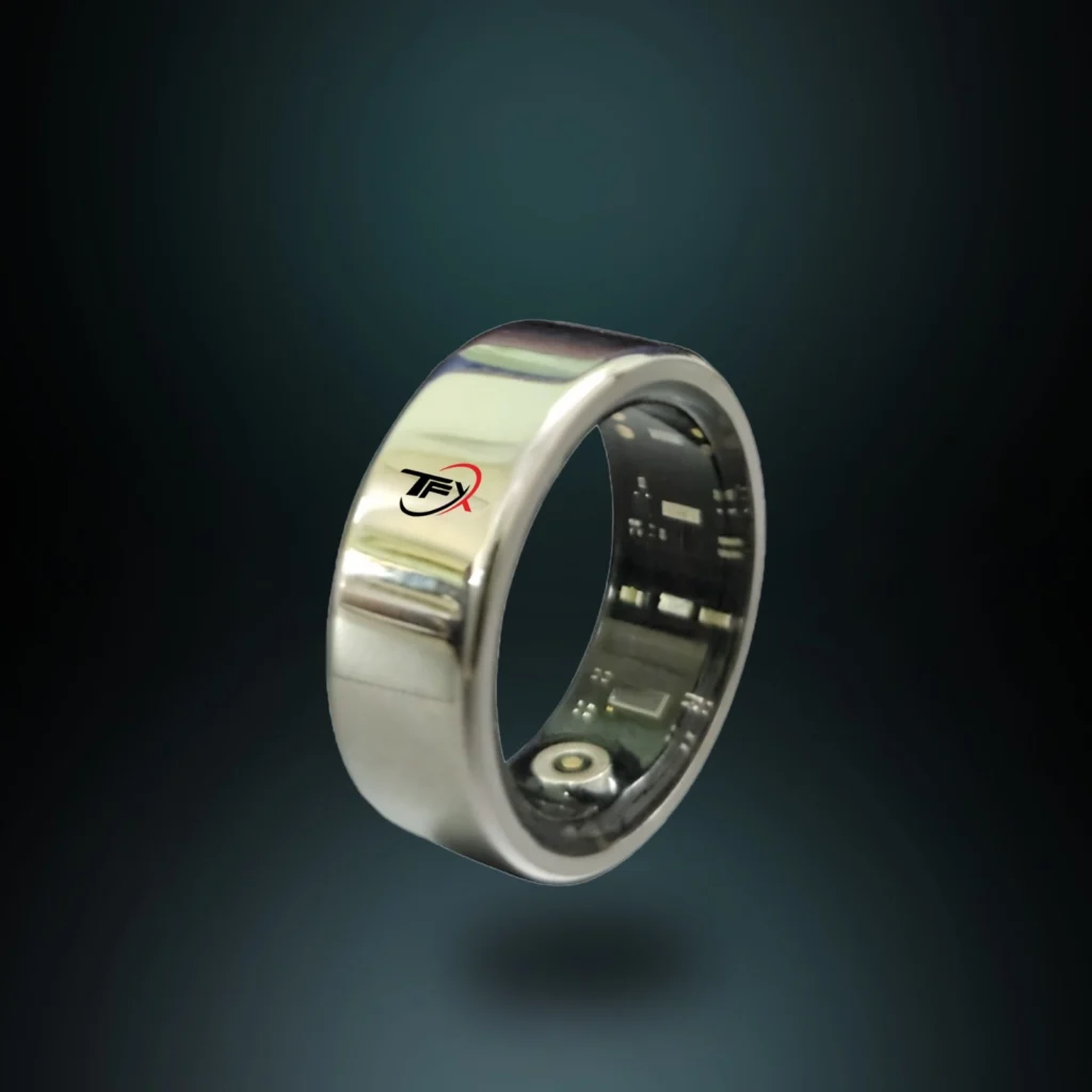 A close-up of a gold Oura Ring Generation 3, a smart ring for health and fitness tracking, showing its logo on the outer band and internal sensors